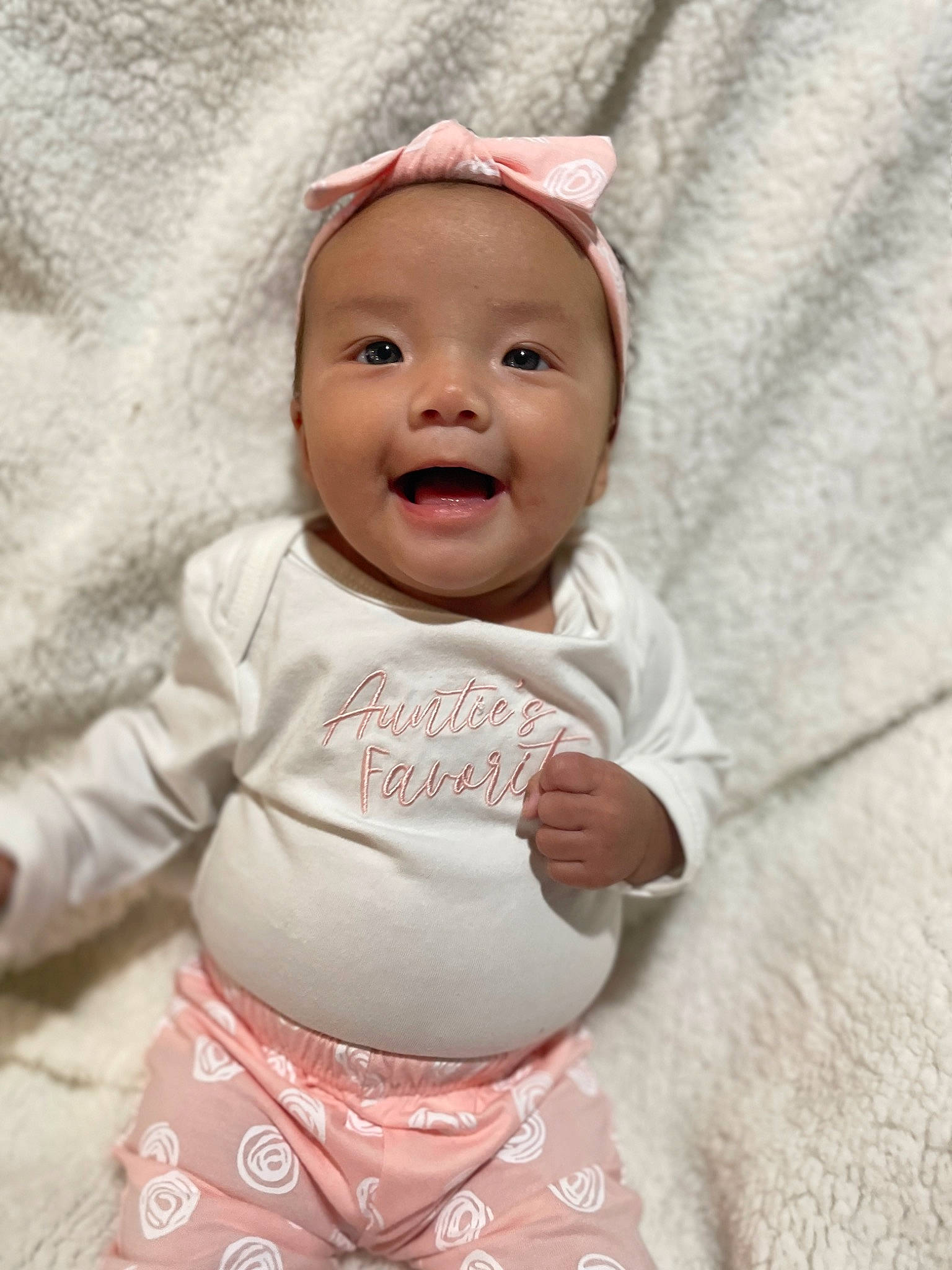 Milanya is registered to the contest to win money with this photo: baby, baby_toddler_clothing, cap, cheek, chin, comfort, eye, face, gesture, happy, headwear, linens, nose, person, pink, skin, sleeve, smile, textile, thumb