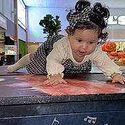 Julieth Camila Novoa joined the competition — help win amazing prizes! toddler, child, indoor, crawling, curly_hair, bow, patterned_clothing, music_notes, pumpkin, mall, plant, table, face, hands, headband, long_sleeve, floor, lighting, curiosity, person