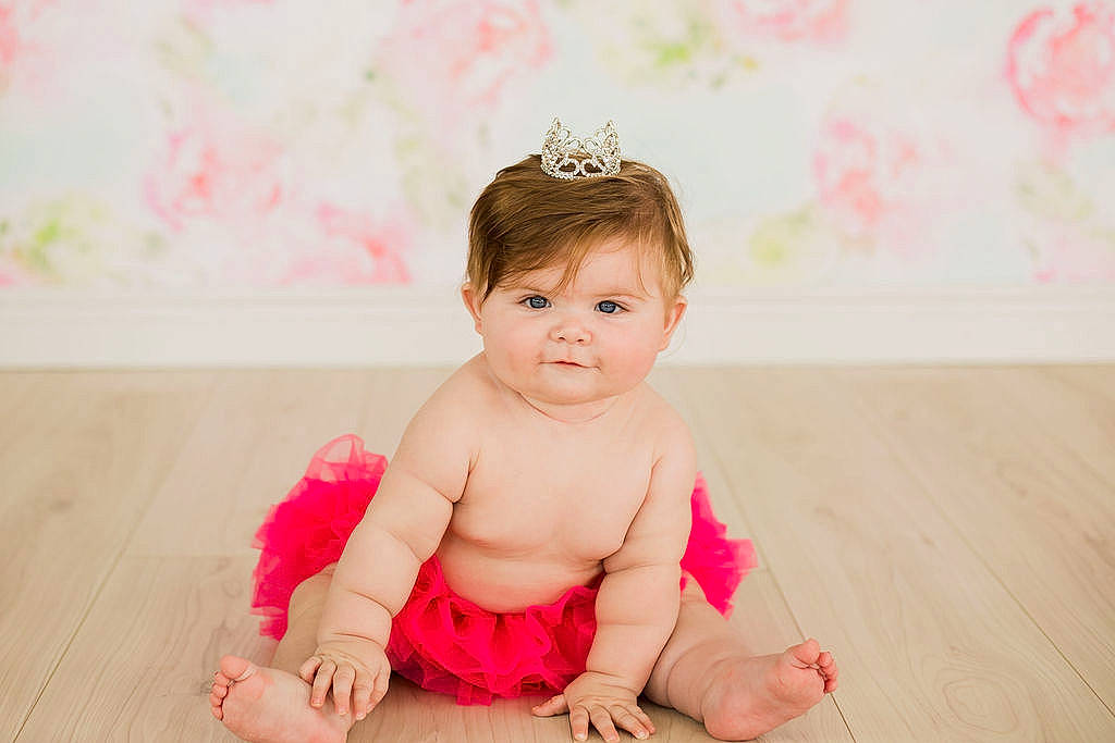 Vivian is registered to the contest to win money with this photo: arm, baby, baby_toddler_clothing, barefoot, cheek, child, ear, flash_photography, floor, flooring, gesture, grass, happy, headpiece, human_leg, magenta, person, pink, skin, sleeve