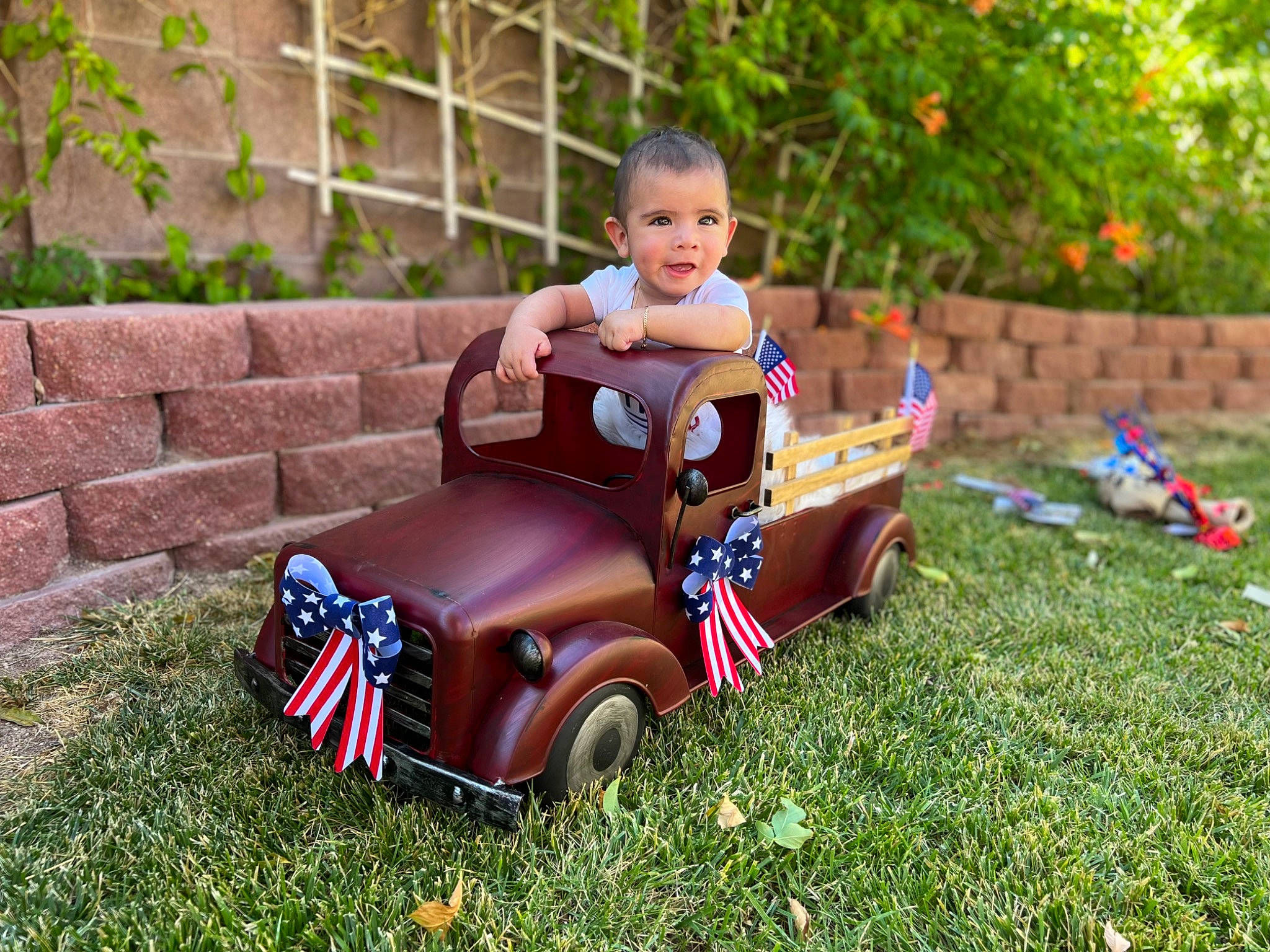 Alec is registered to the contest to win money with this photo: automotive_design, automotive_tire, automotive_wheel_system, car, dress, grass, happy, leisure, motor_vehicle, orange, person, plant, public_space, riding_toy, summer, tire, toddler, toy, vehicle, wheel