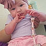 baby, infant, child, headband, pink, purple, pacifier, pacifier_clip, skirt, sitting, hand, face, curious, indoor, person, clothing, cute, bottle, sippy_cup, holding