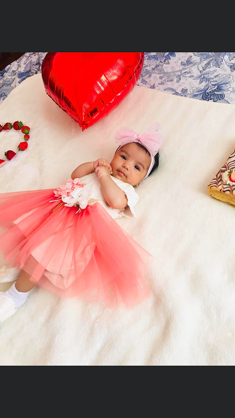 Vanesa participe au concours pour gagner de l'argent avec cette photo : baby, baby_toddler_clothing, bridal_accessory, child, dress, embellishment, event, flash_photography, flooring, fun, happy, headpiece, headwear, linens, magenta, person, petal, pink, red, sleeve