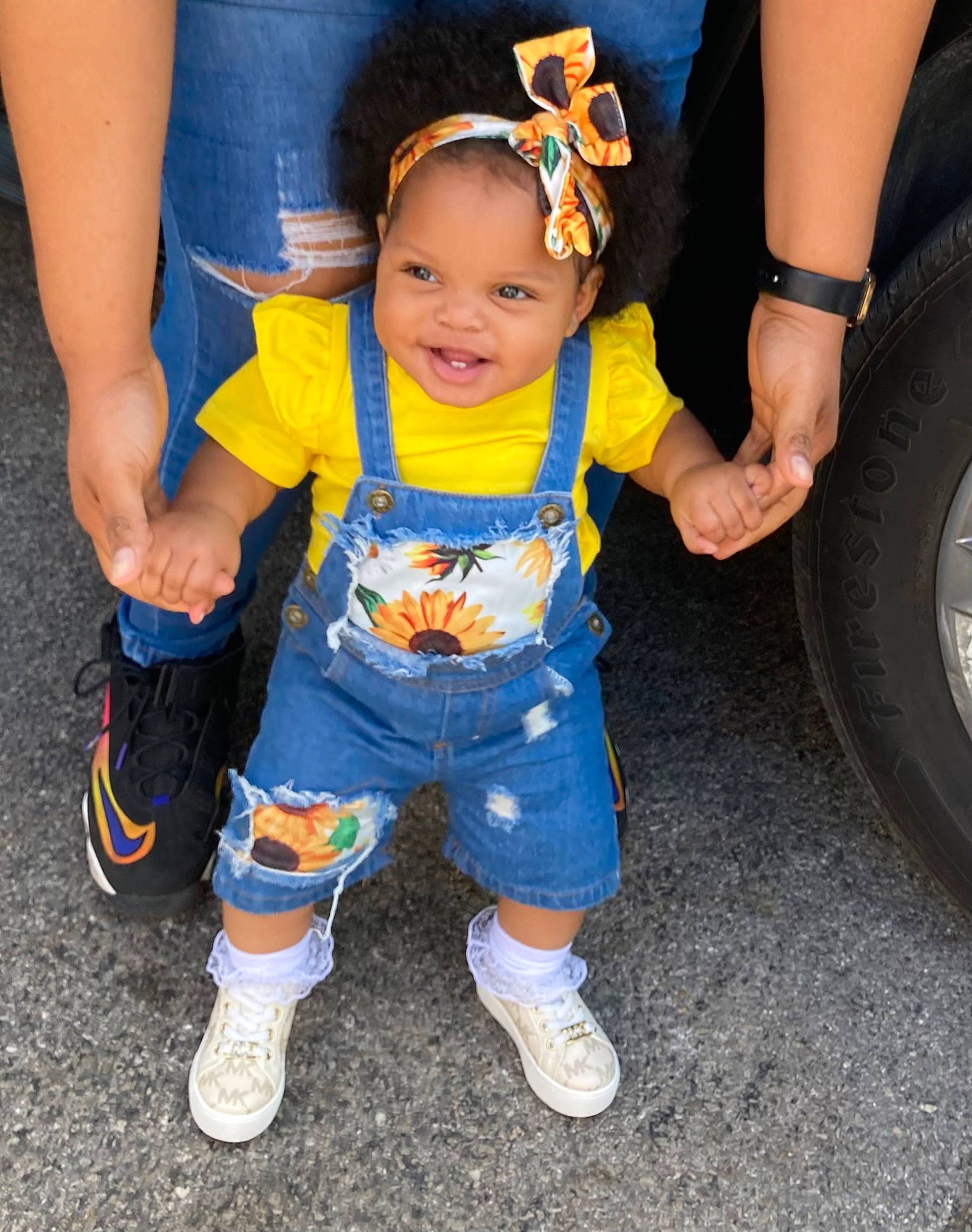 Carmen is registered to the contest to win money with this photo: arm, baby, baby_toddler_clothing, electric_blue, eye, facial_expression, fender, fun, hand, happy, hat, leg, person, shoe, smile, sneakers, tire, tire_care, toddler, tread