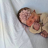 Hadley joined the competition — help win amazing prizes! baby, blanket, calm, closeup, cozy, cute, flower, headband, human, indoors, infant, knitted_clothing, newborn, peaceful, portrait, resting, sleeping, small_hands, soft_texture, tender