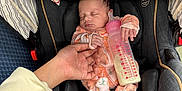 Alayah is registered to the contest to win money with this photo: baby, bottle, car_seat, child, clothing, cozy, cute, fabric, feeding, hand, holding, indoor, infant, newborn, parent, person, pink, resting, sleeping, toddler