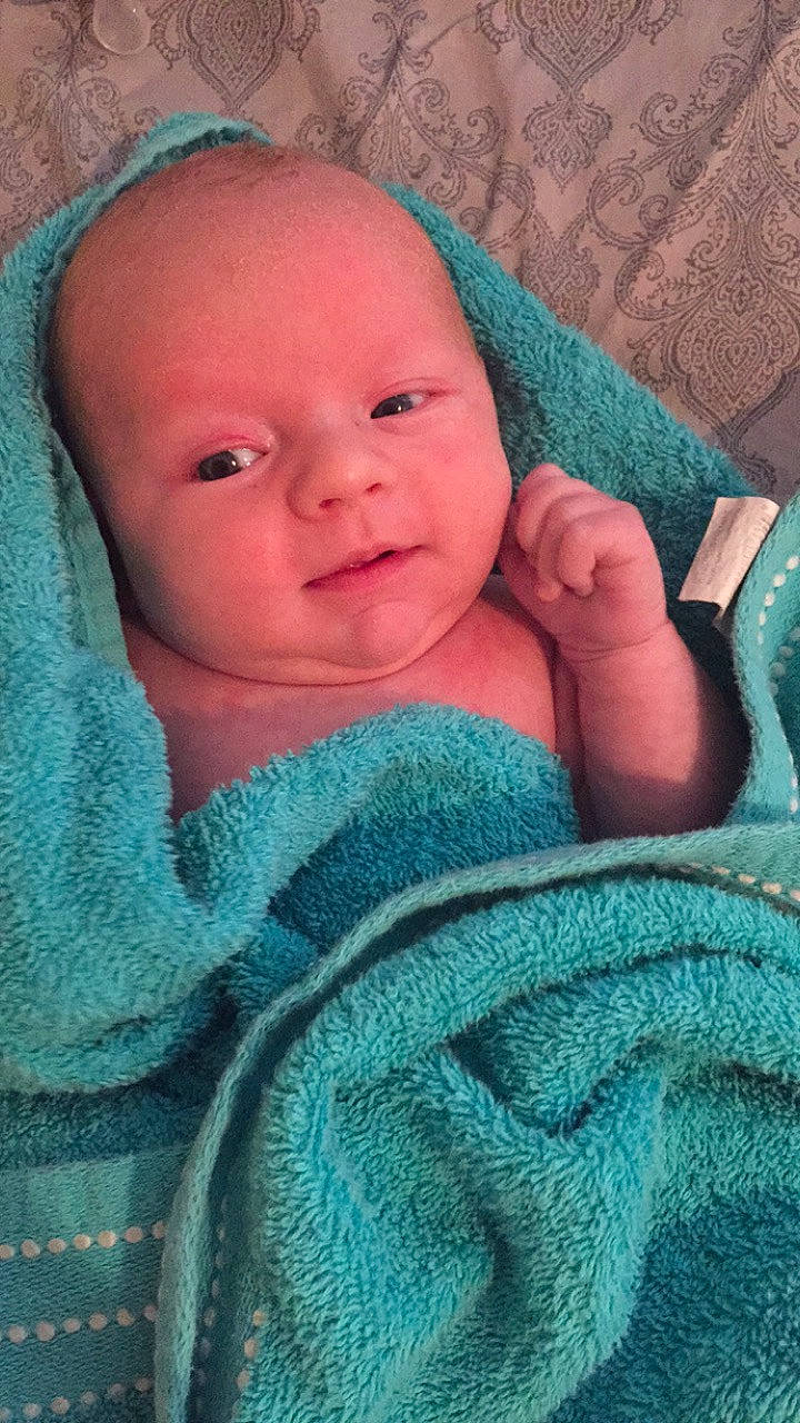 Lawson joined the competition — help win amazing prizes! baby, blanket, cheek, child, eye, face, head, knitting, linens, lip, nose, person, skin, textile, toddler, turquoise, wool