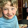Lawson is registered to the contest to win money with this photo: blond_hair, blue_shirt, boy, casual_clothing, child, childhood, face, freckles, furniture, hand, happy, head, indoor, person, portrait, relaxed, room, sitting, smile, young
