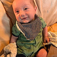 Knox joined the competition — help win amazing prizes! baby, bib, blanket, checkered, child, couch, cute, dinosaur_print, green_onesie, hand, happy, head, indoors, infant, leather, portrait, seated, skin, smile, young