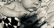 Knox is registered to the contest to win money with this photo: baby, black_and_white, blanket, closeup, comfort, couch, expression, face, foot, hand, indoor, infant, newborn, person, portrait, skin, soft, texture, wrapped, young