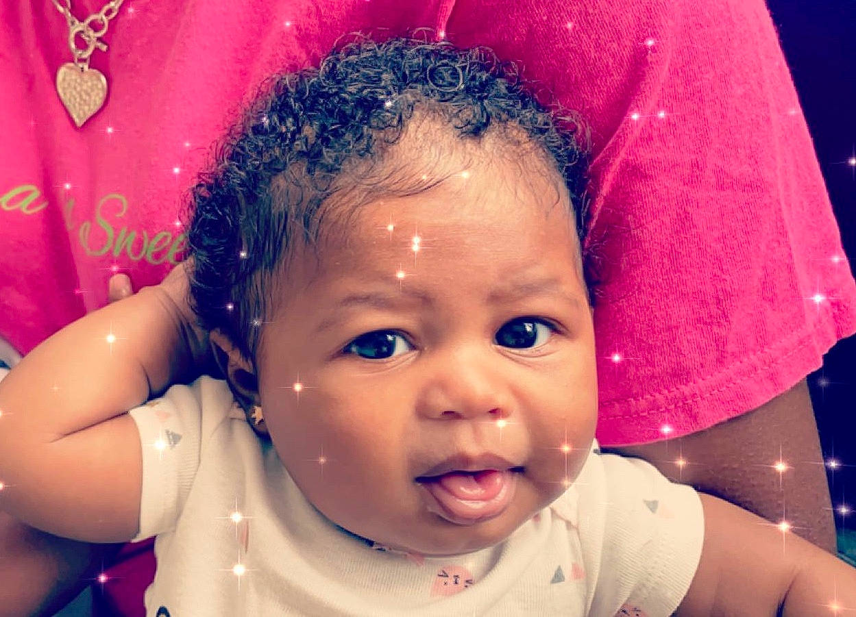 Jai is registered to the contest to win money with this photo: baby, beauty, cheek, child, chin, eye, eyebrow, face, facial_expression, forehead, fun, hair, happy, head, lip, nose, person, pink, skin, smile