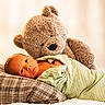 newborn, baby, teddy_bear, blanket, pillow, soft_toy, infant, wrapped, cute, sleeping_area, bedroom, portrait, cozy, child, plush, comfort, indoor, resting, cuddly, warm