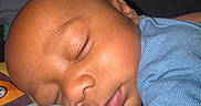 Javeon is registered to the contest to win money with this photo: baby, blue_clothing, child, closeup, cozy, cute, eyelids, face, hand, indoors, infant, lips, nose, peaceful, portrait, rest, skin, sleeping, soft, young