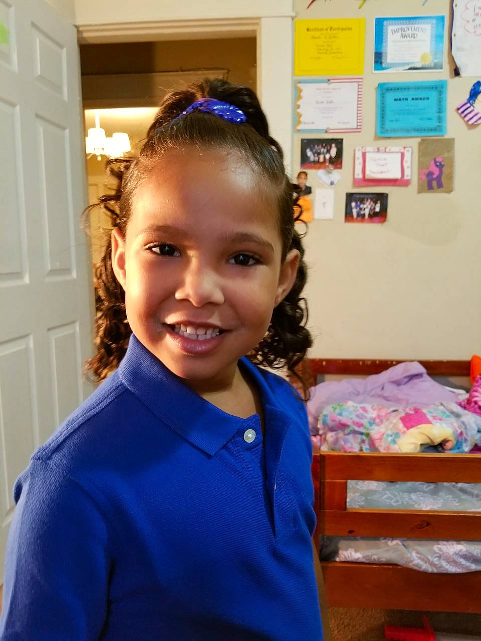 Janiyah is registered to the contest to win money with this photo: audio_equipment, child, chin, clothing, door, electric_blue, event, fashion_accessory, fun, hair_tie, hairstyle, happy, headband, hearing, joy, person, room, sleeve, smile, t_shirt