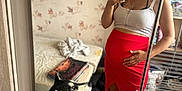 Yougo participe au concours pour gagner de l'argent avec cette photo : woman, mirror_selfie, dog, husky, red_skirt, white_top, red_bandana, bedroom, bed, clothes, laundry_rack, smiling, pet, indoor, casual, footwear, sneakers, reflection, hand_on_belly, happy