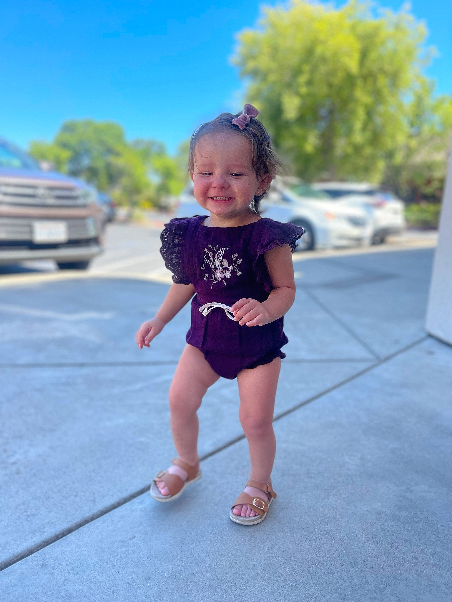 Oakley is registered to the contest to win money with this photo: asphalt, baby_toddler_clothing, car, city, denim, electric_blue, grass, happy, head, human_leg, joy, knee, leisure, person, recreation, sky, t_shirt, thigh, tire, toddler