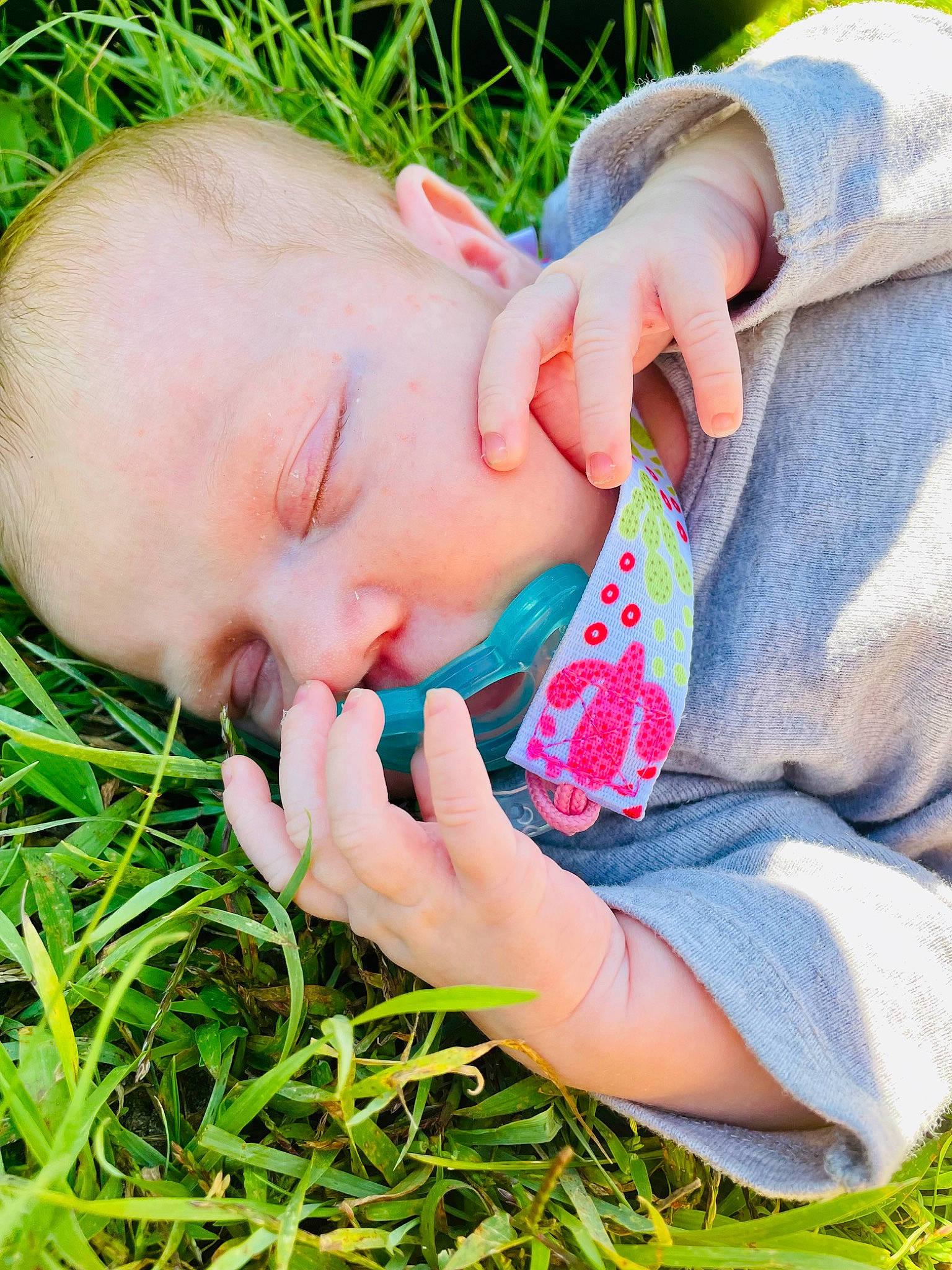 Aspyn is registered to the contest to win money with this photo: baby, baby_toddler_clothing, child, finger, gesture, grass, grass_family, grassland, hand, happy, lip, mouth, nail, nose, people_in_nature, person, plant, skin, thumb, toddler