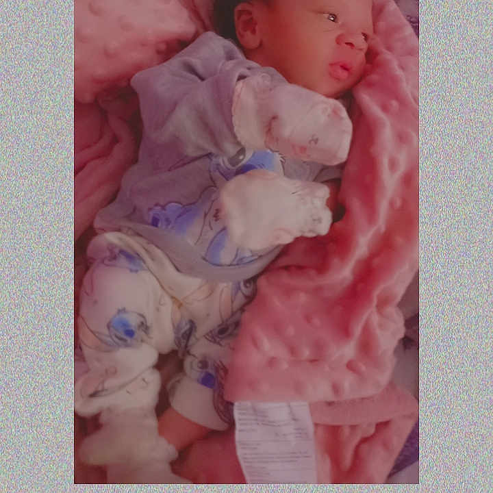 Tynae is registered to the contest to win money with this photo: baby, bed, bedroom, blanket, bonnet, clothing, couch, crib, face, furniture, hat, head, indoors, infantbed, newborn, person, photography, portrait, sleeping, toy