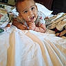 Karter joined the competition — help win amazing prizes! baby, infant, child, portrait, lying_down, tummy_time, bed, bedroom, blanket, bedsheets, pajamas, smiling, curious, face, eyes, hands, indoor, home, photograph, phone_screenshot