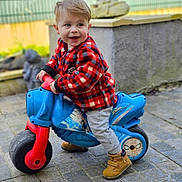 Sloan participe au concours pour gagner de l'argent avec cette photo : boy, child, clothing, face, footwear, glove, head, jeans, machine, male, pants, path, person, photography, portrait, shoe, sitting, transportation, vehicle, wheel