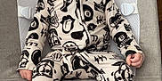 Ace joined the competition — help win amazing prizes! baby, infant, onesie, patterned_clothing, baby_seat, face, blue_eyes, serious_expression, indoor, wooden_floor, fabric, comfort, head_support, baby_clothes, child, person, cute, small_hands, footed_pajamas, sitting