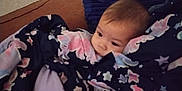 Theodore is registered to the contest to win money with this photo: baby, blanket, couch, pillow, indoor, child, face, resting, cozy, fabric, colorful, pattern, clothing, head, person, comfort, portrait, young, soft, relaxing