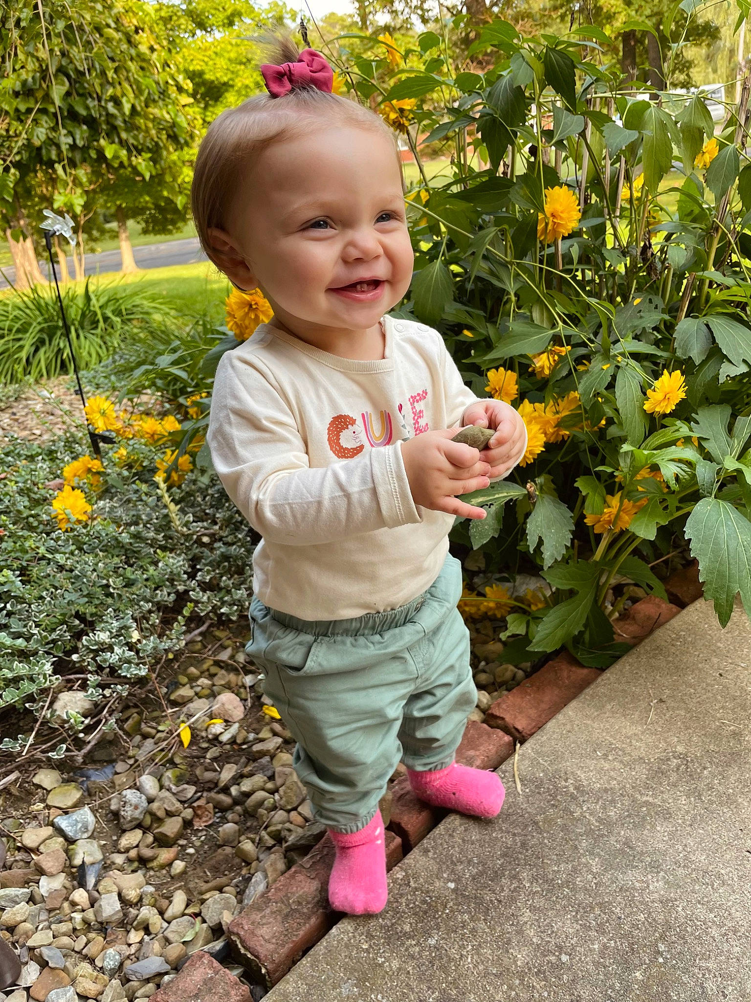 Myla is registered to the contest to win money with this photo: annual_plant, baby, baby_toddler_clothing, botany, flower, flowering_plant, fun, garden, grass, happy, head, joy, leaf, orange, people_in_nature, person, plant, shrub, smile, toddler