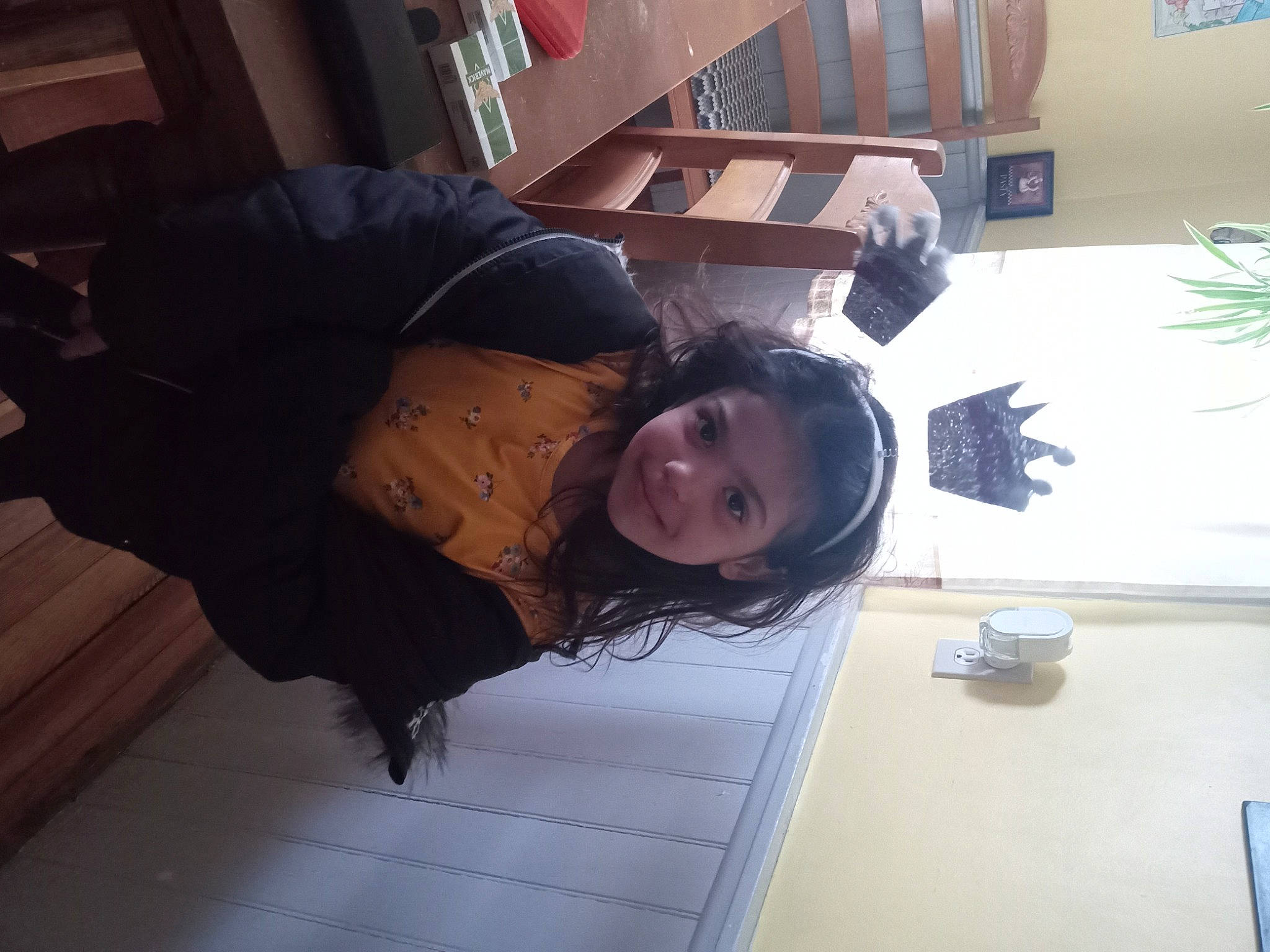 Annamarie joined the competition — help win amazing prizes! black_hair, comfort, floor, flooring, fun, fur, hardwood, houseplant, human_leg, joy, person, plant, room, shelf, sitting, thigh, wood, wood_flooring