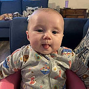 Kinsleigh joined the competition — help win amazing prizes! baby, child, tongue_out, onesie, clothing, indoor, living_room, couch, dog, seat, pink, blue, floor, wooden_floor, face, person, cute, playful, smile, infant