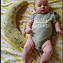 Kinsleigh is registered to the contest to win money with this photo: baby, infant, onesie, green_clothing, yellow_flower_pattern, crescent_pillow, bed_sheet, lying_down, face, cute, child, indoors, soft_toy, person, newborn, pillow, patterned_fabric, skin, expression, resting