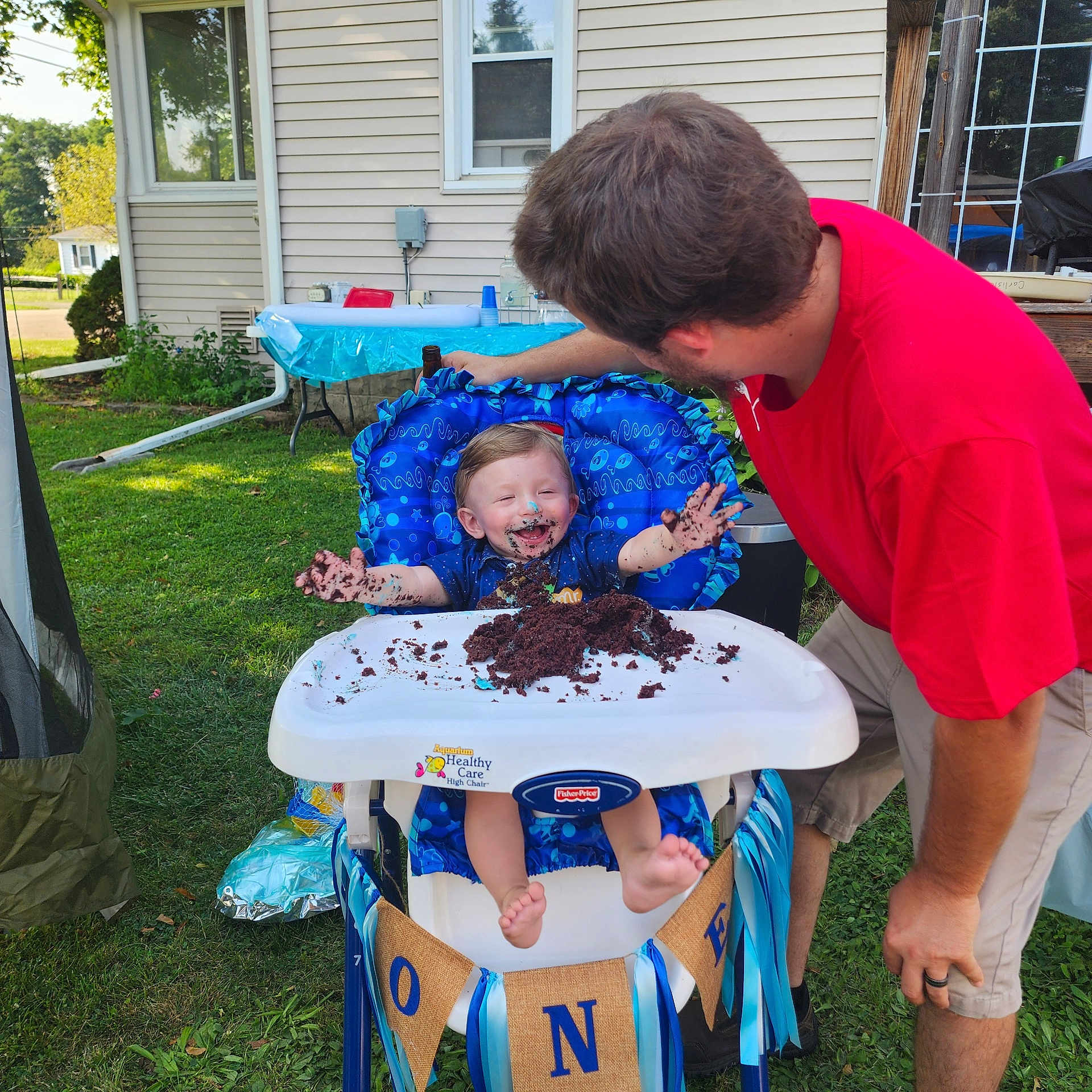 Austin is registered to the contest to win money with this photo: adult, backyard, birthdaycake, cake, cream, dessert, face, food, grass, head, icing, male, nature, outdoors, person, photography, plant, portrait, summer, yard