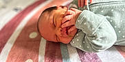 Hazel is registered to the contest to win money with this photo: newborn, baby, infant, sleeping, blanket, striped, onesie, green_clothing, hands, face, peaceful, soft, cute, portrait, closeup, indoors, child, toddler, resting, cozy