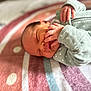 newborn, baby, infant, sleeping, blanket, striped, onesie, green_clothing, hands, face, peaceful, soft, cute, portrait, closeup, indoors, child, toddler, resting, cozy