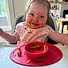 Madelyn joined the competition — help win amazing prizes! toddler, child, high_chair, messy, spaghetti, food, food_on_face, smiling, happy, indoor, plate, pink_plate, bib, meal_time, kitchen, person, blue_eyes, hair_tied, table, mess