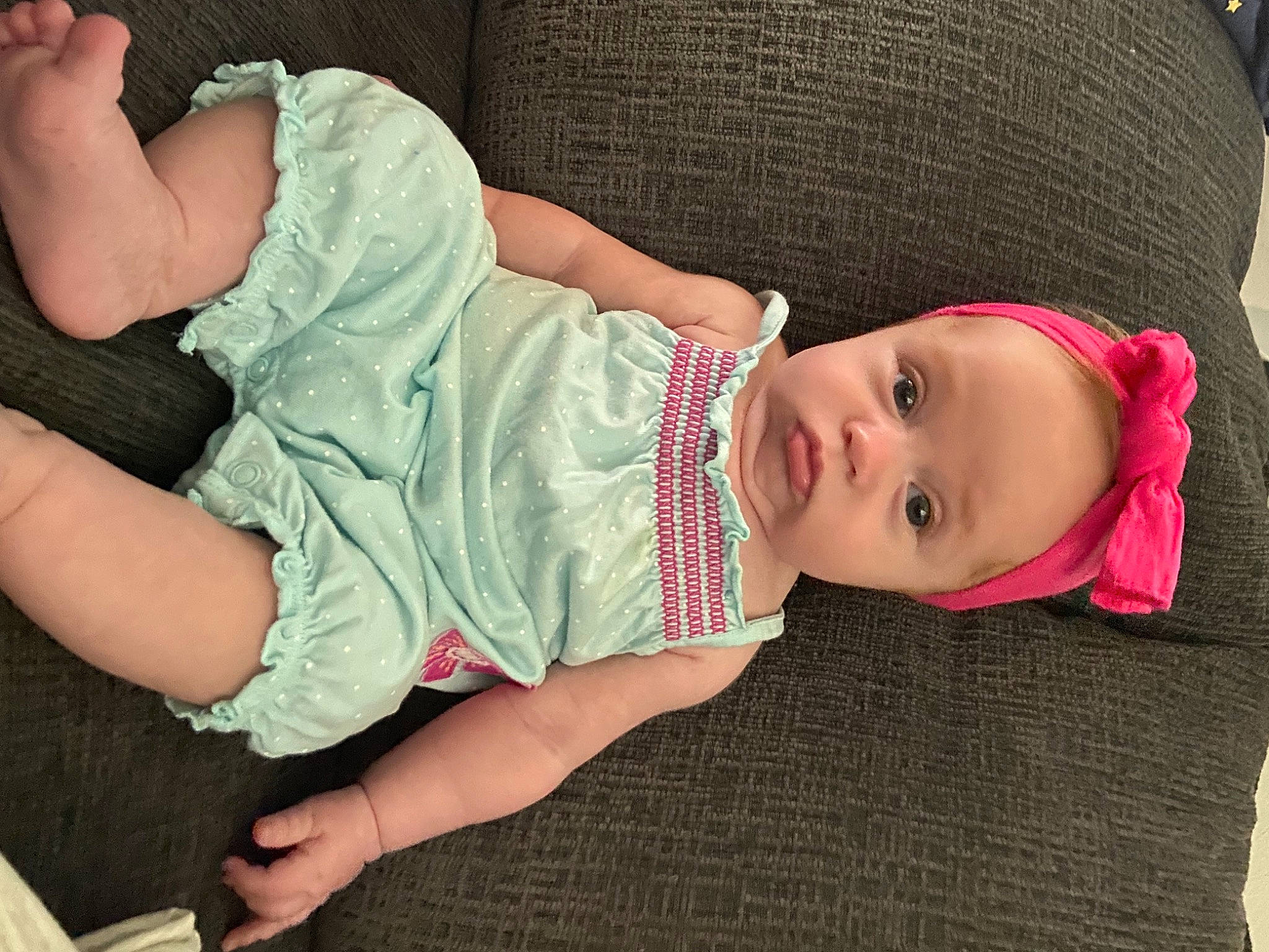 Brooklynn is registered to the contest to win money with this photo: arm, baby, baby_toddler_clothing, cheek, child, comfort, facial_expression, hand, human_body, joint, mouth, neck, pattern, person, pink, product, skin, sleeve, smile, thigh