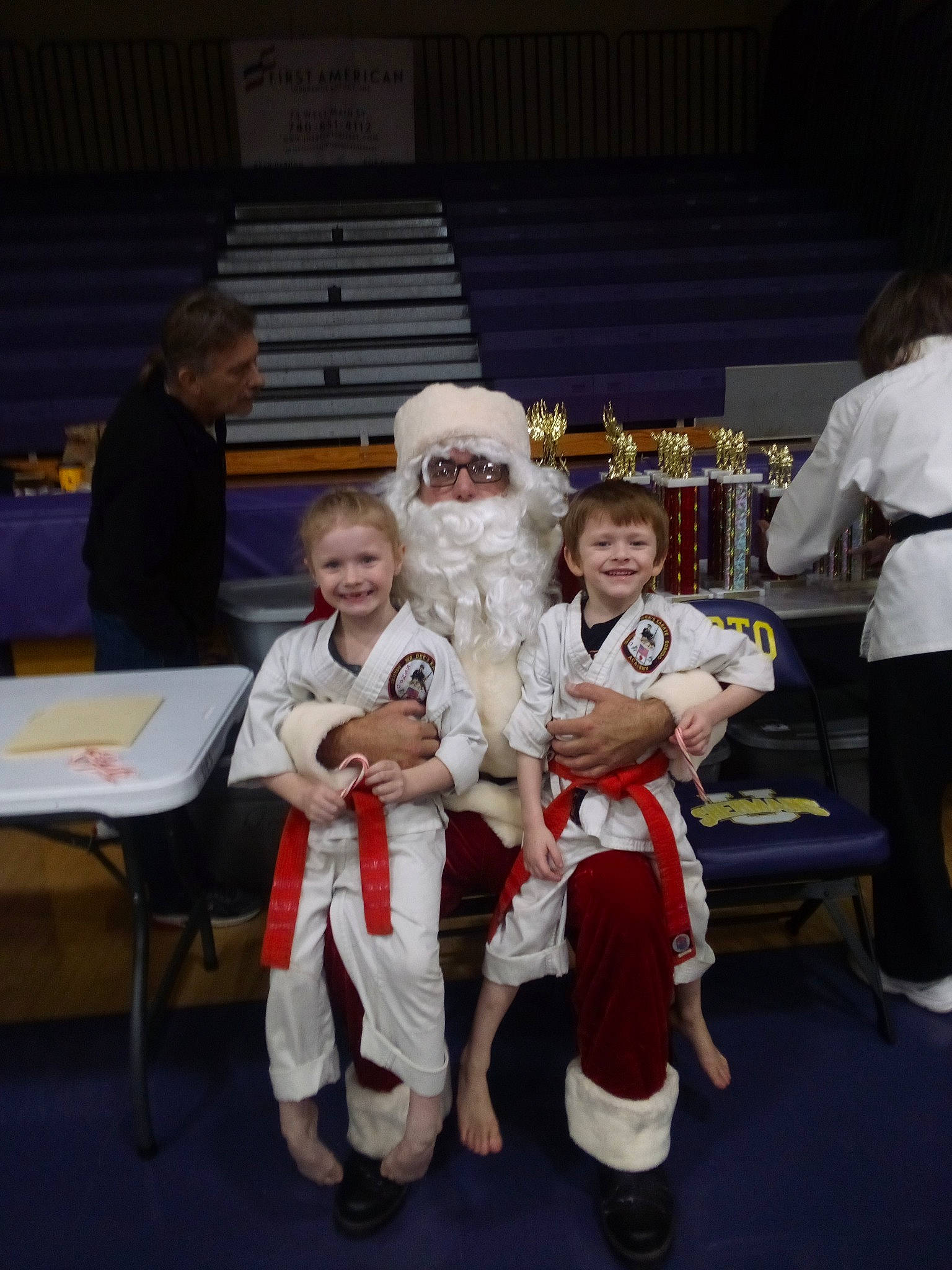 Kaydence is registered to the contest to win money with this photo: boot, chair, child, competition_event, costume, event, fictional_character, fun, fur, hat, joy, mascot, person, recreation, santa_claus, shorts, smile, t_shirt, table, team