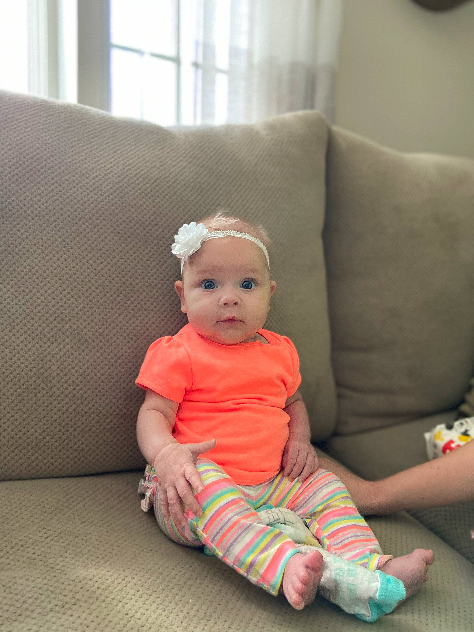 Elliot is registered to the contest to win money with this photo: baby, baby_toddler_clothing, child, ear, floor, flooring, furniture, headwear, leg, person, pink, room, sitting, skin, sleeve, toddler