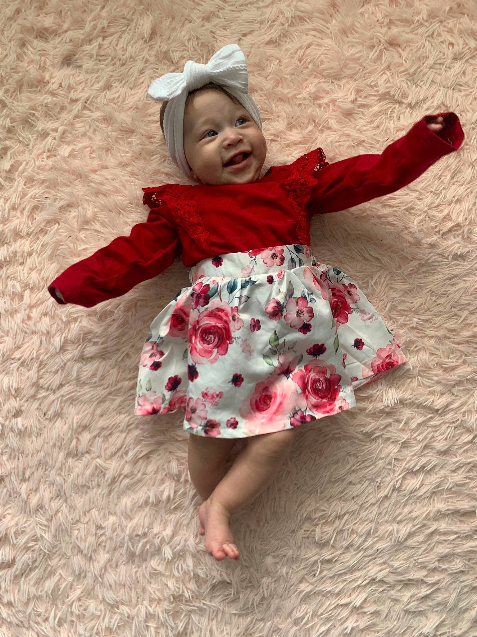 Kailani is registered to the contest to win money with this photo: baby, baby_toddler_clothing, barefoot, child, dress, face, foot, fun, happy, head, headwear, human_leg, magenta, one_piece_garment, pattern, people_in_nature, person, pink, sandal, sleeve