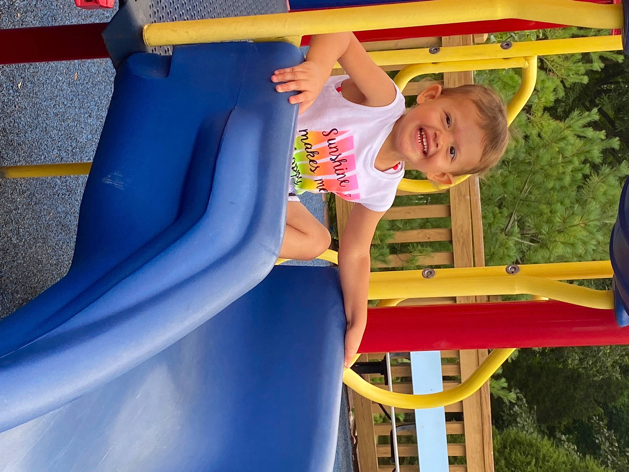 Kinsley is registered to the contest to win money with this photo: child, chute, city, electric_blue, fun, grass, happy, joy, leisure, outdoor_play_equipment, people_in_nature, person, play, playground, playground_slide, recreation, shade, shorts, smile, t_shirt