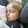 Ophélie a rejoint le concours — aidez-le/la à gagner de superbes lots ! blanket, car_seat, child, closeup, clothing, comfort, cozy, face, flower_clip, hair_accessory, indoors, nap, peaceful, portrait, rest, seatbelt, sleeping, soft_light, toddler, young_child
