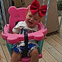 toddler, child, swing, pink_swing, red_bow, smiling, happy, outdoor, wooden_deck, cardboard_box, summer_clothes, barefoot, playtime, fun, rope, seat, person, baby, cute, cheerful