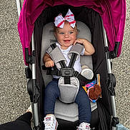 Paityn joined the competition — help win amazing prizes! baby, bottle, bow, canopy, casual, child, clothing, footwear, happy, jeans, outdoor, parent, pavement, person, seatbelt, smile, sneakers, stroller, toy, walking