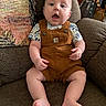 baby, child, infant, sitting, armchair, brown_overall, patterned_shirt, curious, indoors, furniture, cute, chubby, face, open_mouth, hands, legs, feet, home, comfortable, portrait