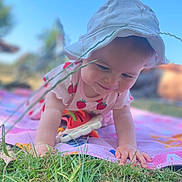 Josie-Leigh joined the competition — help win amazing prizes! baby, blanket, blue_sky, child, crawling, cute, grass, greenery, hat, infant, nature, outdoor, person, playful, smiling, strawberry_pattern, summer, sunhat, sunlight, toy