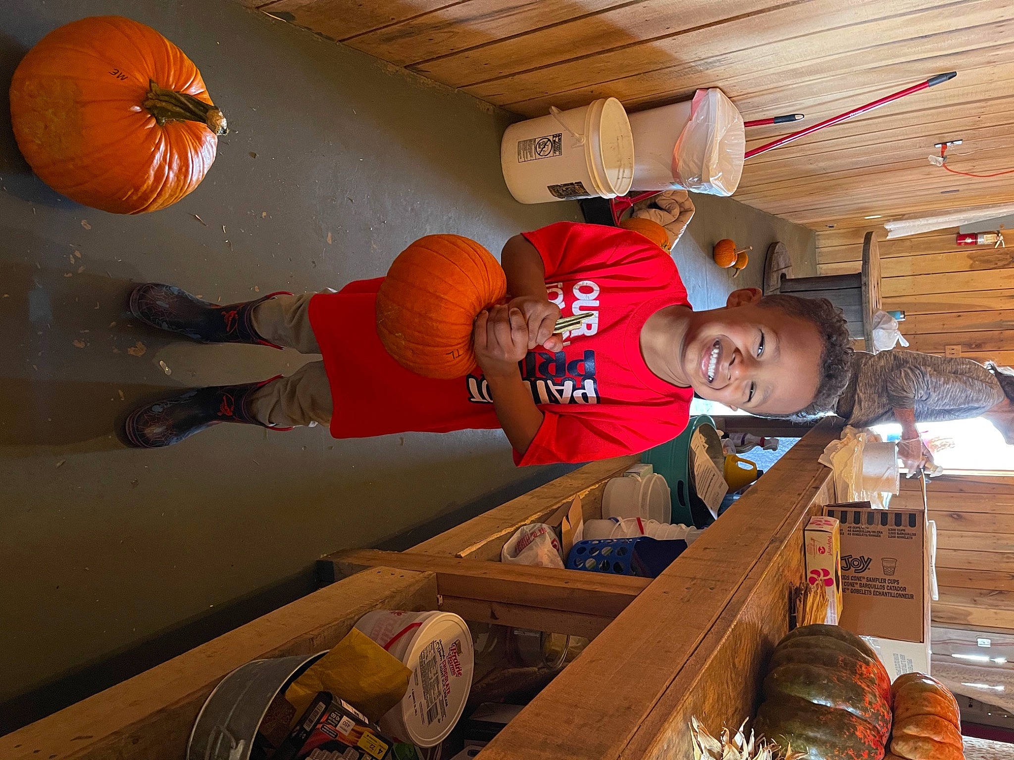 Tavion joined the competition — help win amazing prizes! beam, building, calabaza, ceiling, flooring, fun, hardwood, hat, joy, lumber, orange, person, room, smile, t_shirt, wood