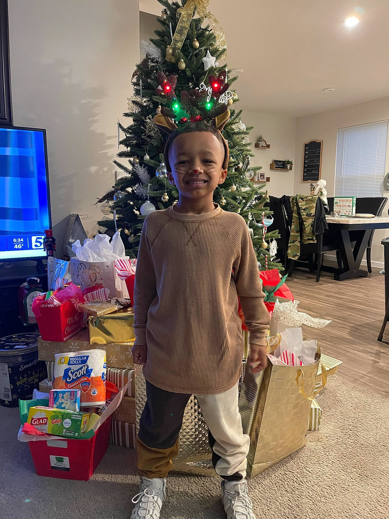 Tavion joined the competition — help win amazing prizes! chair, christmas, christmas_decoration, christmas_eve, christmas_ornament, christmas_tree, conifer, event, evergreen, fun, holiday, holiday_ornament, home, joy, lap, ornament, person, plant, room, smile