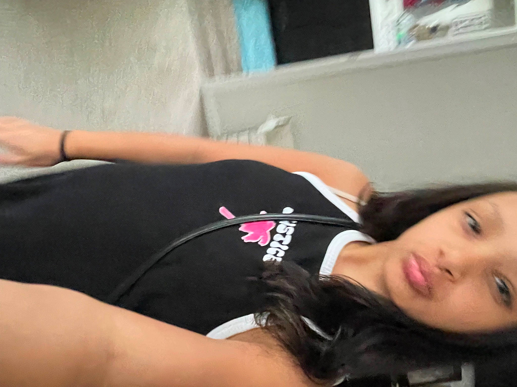 Taniya is registered to the contest to win money with this photo: abdomen, black_hair, chest, comfort, elbow, eyelash, flesh, human_leg, knee, person, room, sitting, sleeve, sportswear, t_shirt, tattoo, thigh, throat, trunk, waist