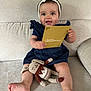 Agathe a rejoint le concours — aidez-le/la à gagner de superbes lots ! baby, child, smiling, headband, bow, blue_dress, knitted_toy, bunny, couch, beige, indoor, happy, sitting, holding, card, cute, portrait, infant, toy, feet
