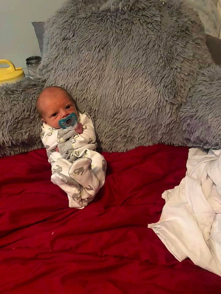 Julian is registered to the contest to win money with this photo: baby, bedding, bedtime, child, christmas, comfort, fur, fur_clothing, lap, linens, nap, person, room, santa_claus, sitting, sleep, textile, throw_pillow, toddler, toy