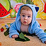 baby, blue_hoodie, child, cute, face, fruit, green_leaves, indoor, kiwi, lemon, orange, photography, portrait, red_strawberry, sitting, surprised, toddler, watermelon, yellow, young_child