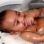 baby, bath, bubble, foam, water, cushion, star_pattern, smile, hand, skin, infant, child, relaxation, cleaning, bathtub, wet, happy, cute, indoors, portrait